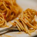 delicious pasta with tomato sauce and herbs served on plate